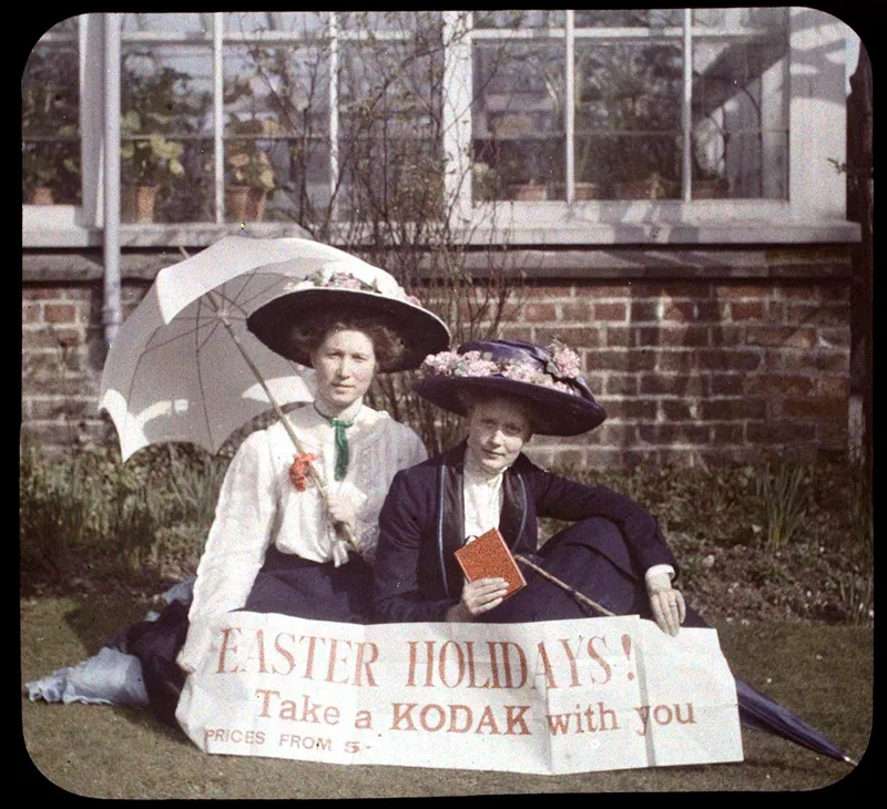 Autochrome - Two women holding a sign that readsEaster Holidays!
